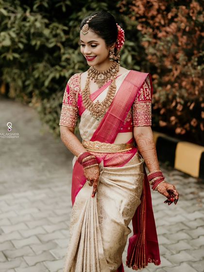 A joyful bride walking towards the camera, her smile and beautiful attire captured perfectly.
