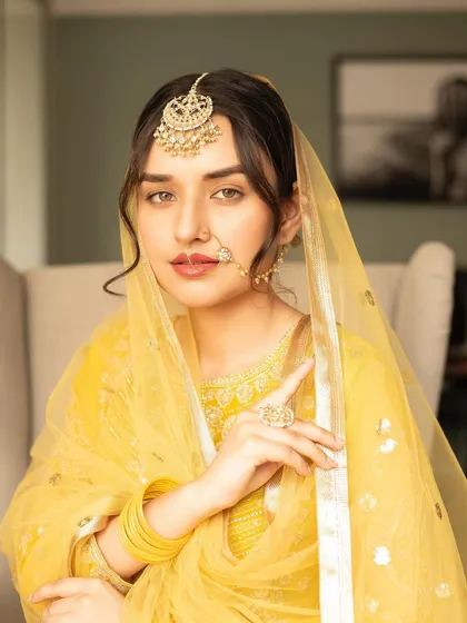 A continuation of the Heeramandi-inspired series. This portrait shows the model's regal pose, with makeup focused on flawless skin and defined, expressive eyes.