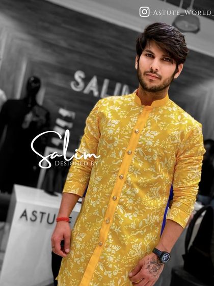 A client wearing a bright yellow floral print kurta. This is a cheerful and stylish option for a mehndi or haldi ceremony.