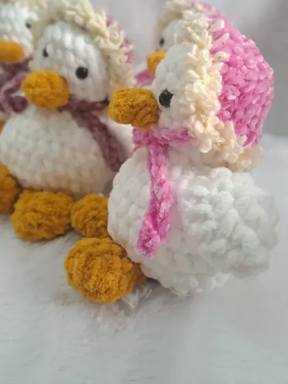 A group of my winter duck plushies, available in different colored hats.