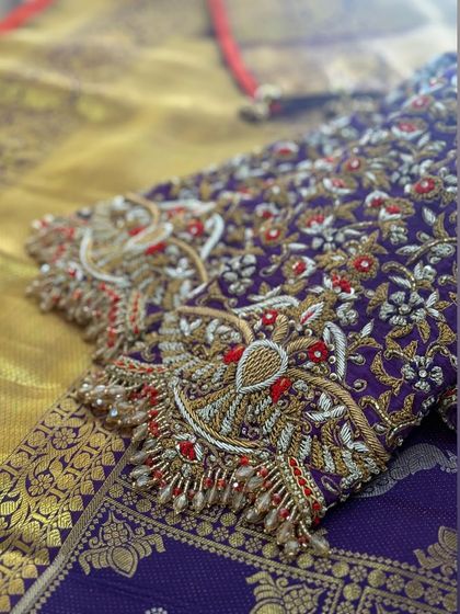 A close-up of the sleeve, showing a peacock motif created with zardosi and threadwork.