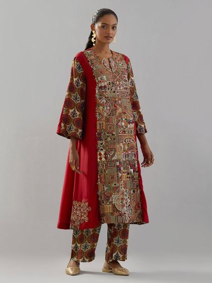 A striking red A-line kurta featuring a panel of dense, architectural-inspired embroidery, blending traditional craft with a modern aesthetic.