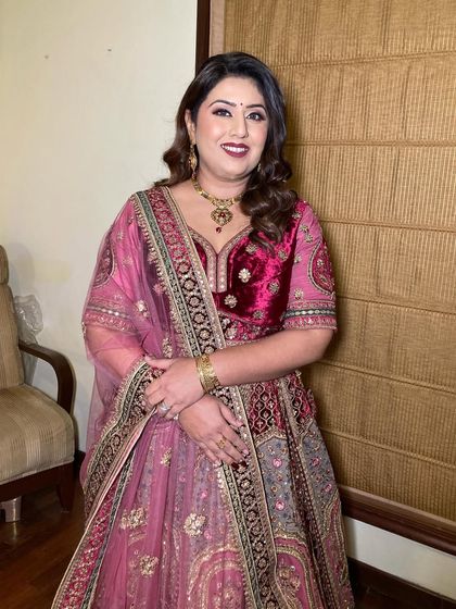 Ruchi looking absolutely radiant for the wedding. We went for a classic glam look with soft waves and a berry lip that beautifully complemented her pink and velvet lehenga.