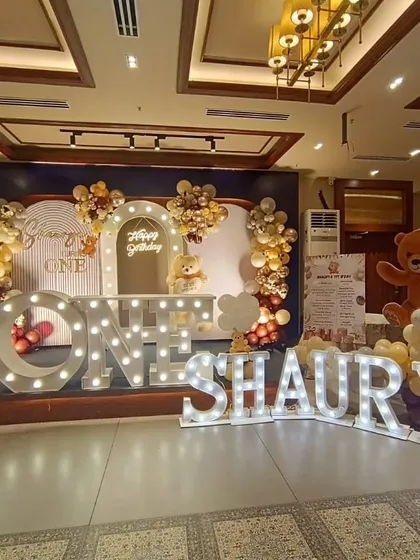 We made Shaurya's first birthday extra special with these giant marquee letters spelling out his name. The teddy bear theme, complete with a lighted "ONE" sign and a beautiful balloon backdrop, created a grand and adorable stage for the celebration.