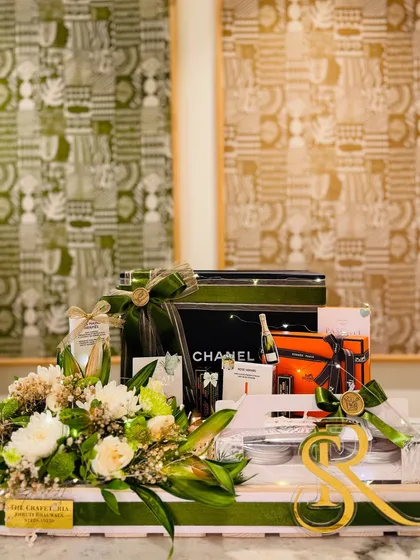 The bespoke bridal gift tray, featuring luxury items from Chanel and Hermès, personalized with the couple's initials. This is where sophistication meets heartfelt sentiment.