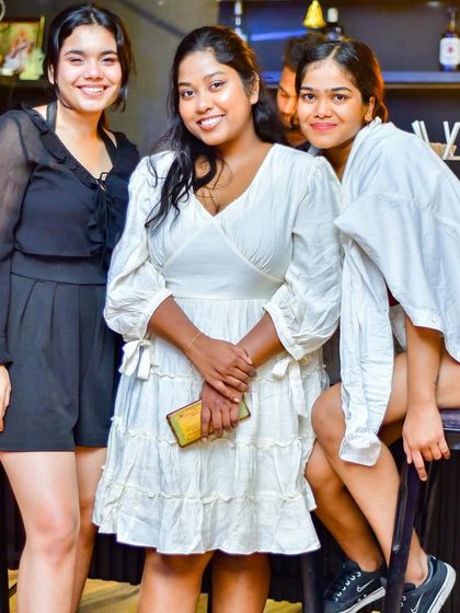 A group of friends in chic white outfits, enjoying the midweek break at End of the Day.