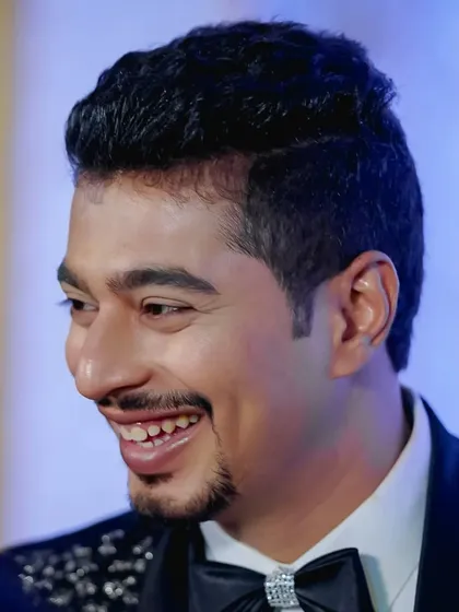 A joyful, candid shot of a groom at his reception. This shows how my makeup work holds up, looking fresh and natural even during lively moments.