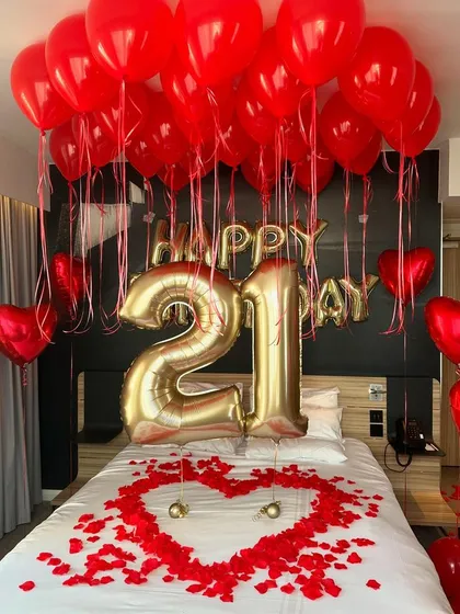 I specialize in creating unforgettable midnight surprises. This romantic bedroom decoration includes ceiling balloons, large foil number balloons for the age, and a heart made of rose petals on the bed to make your loved one feel truly special.