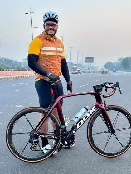 A rider proudly posing with his LOOK road bike, ready to take on the miles.