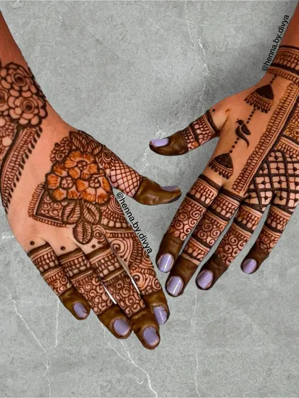 A beautiful fusion design for a party. One hand features a floral and grid pattern, while the other showcases a more traditional layout with jhumka and bird motifs.