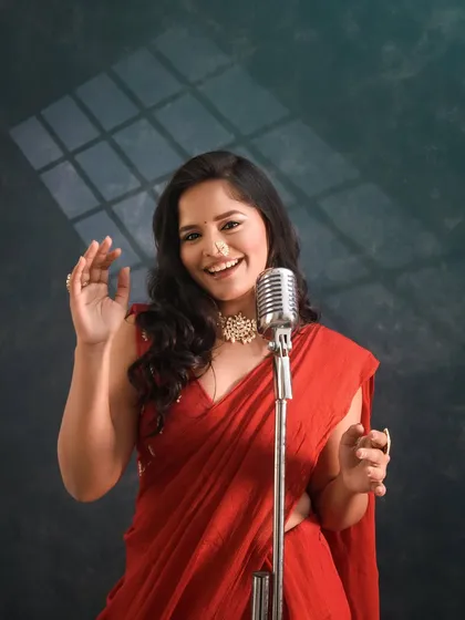 A fun shot with a vintage microphone, adding a retro vibe to the modern outfit.