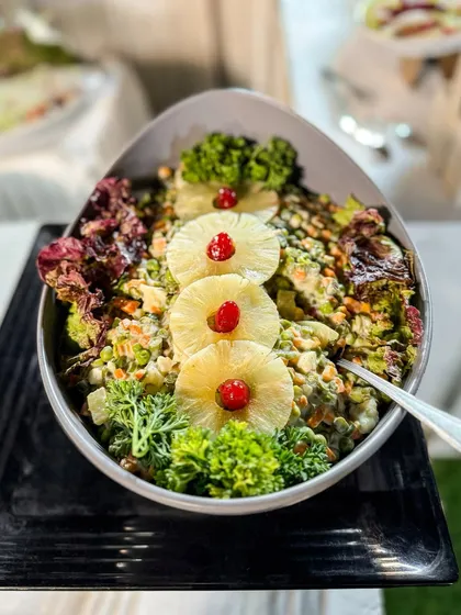 A beautifully composed salad with pineapple and broccoli. Our salads are a fresh, healthy, and colourful addition to any buffet.
