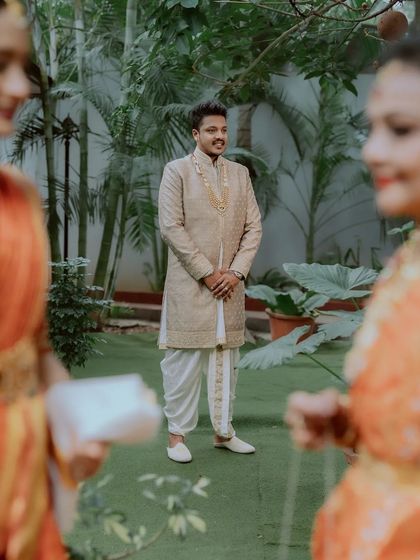 The groom waits with a smile as his bride is about to make her entrance.