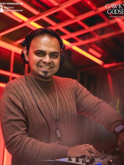 A great portrait of me smiling behind the decks at my home turf, Gawky Goose.