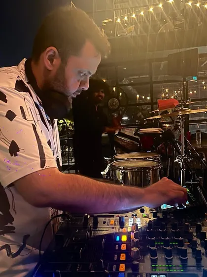 Here you can see me mixing while a live percussionist plays in the background. This combination creates a rich, layered sound for a truly premium experience.