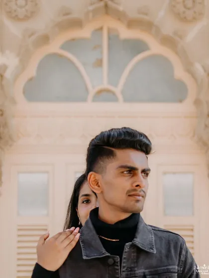 A modern, fashion-inspired portrait at Vijay Vilas Palace. The playful pose, with the bride peeking from behind, adds a touch of personality and charm to this stylish shot against the heritage backdrop.