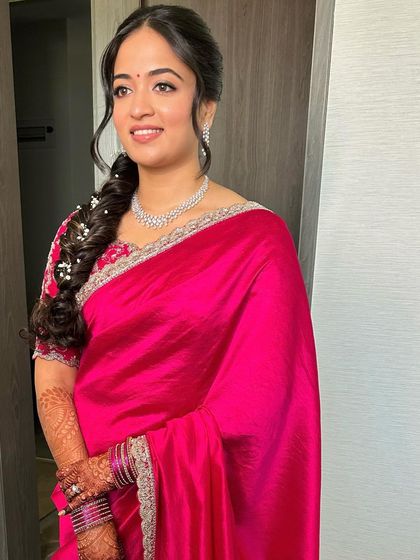 A poised portrait showing the complete look, from the makeup to the hairstyle and saree.