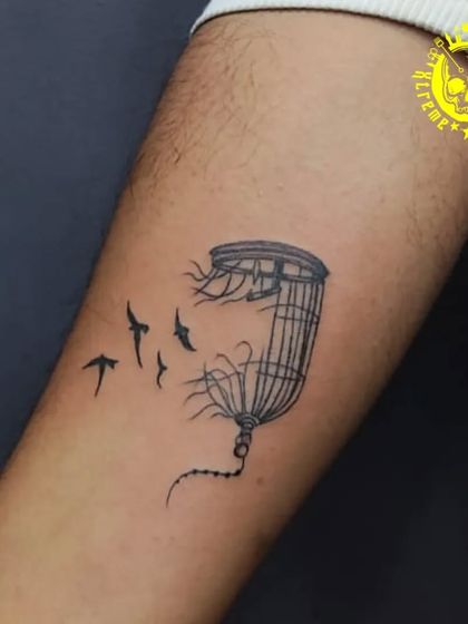 A broken birdcage with birds flying free. This is a powerful and popular symbol of liberation, breaking free from constraints, and finding your own path.