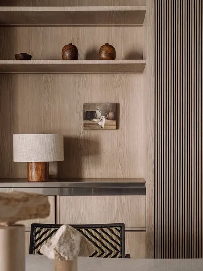A close-up of the beautiful wood grain and fluted details in Kanso House. These subtle textures add warmth and character to the minimalist design.