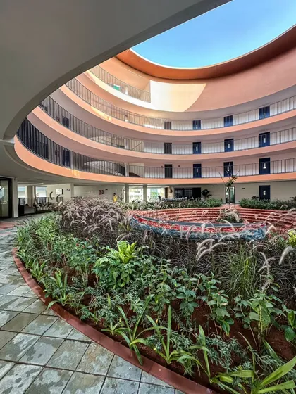 At the core of the school, a circular courtyard with lush, tiered gardens serves as a biophilic sanctuary. This space embodies our commitment to creating environments that foster community and connect occupants with nature, enhancing the daily learning experience.