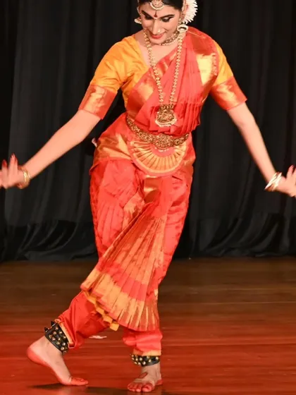 A moment of graceful movement from Kavya Navani's arangetram. The traditional costume and jewelry, combined with the dancer's precise posture, create a picture of classical beauty.