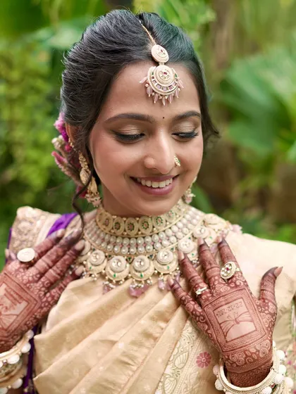 A close-up of this bride's monochromatic look, showing the soft shimmer on the eyes and the detailed mehendi.
