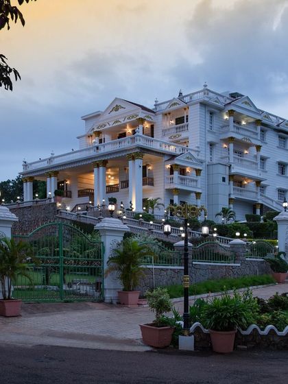 A duplicate image of the palace entrance at dusk, capturing the beautiful transition from day to night.
