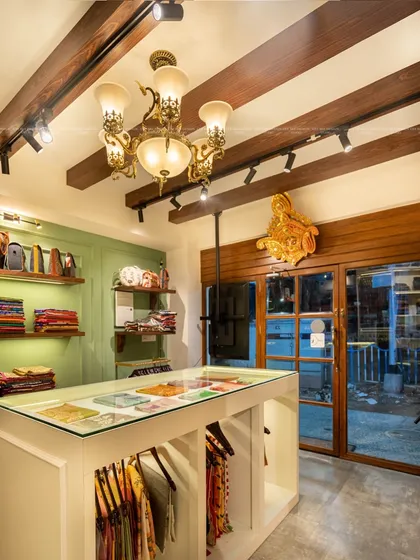 For this traditional sari boutique, I wanted to create an experience, not just a store. I designed the space to feel like a modern 'haveli', using a classic chandelier, wooden beams, and thoughtful displays to transport customers and honor the rich heritage of Indian textiles.