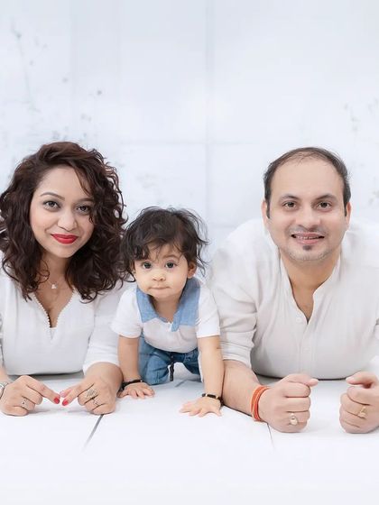 A fun family photo with the baby crawling towards the camera. This captures the playful and unpredictable nature of shooting with little ones.