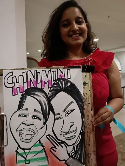 A group of friends with their fun caricature from the Symbiosis college event.