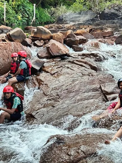 Campers from the KRIES program take a break and enjoy the natural jacuzzis formed by rocks in the river at Dandeli.