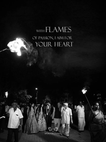 A powerful black and white image of the groom's procession, the flames of the torches lighting up the night.