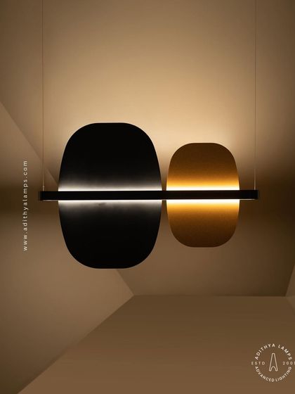 A study in balance and contrast, this fixture features opposing black and gold panels bisected by a line of light. This piece embodies the principle of yin and yang, offering a minimalist yet deeply symbolic lighting solution.