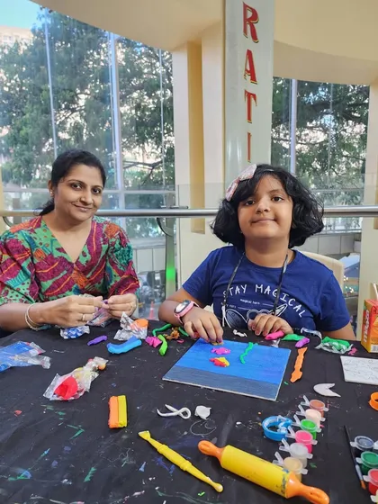 A mother and daughter work together on a clay art project. These shared activities not only teach artistic skills but also create lasting memories for families.