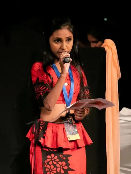A presenter introduces the 'Traditional String Puppet Show from Sri Lanka'. We believe in providing context and background to help our audience appreciate the cultural significance of the performances.