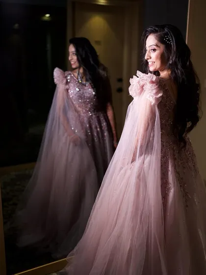 A fairytale moment for this reception bride. The soft, dewy makeup and elegant hairstyle were designed to complement her dreamy pastel gown, creating a look of pure, ethereal elegance.