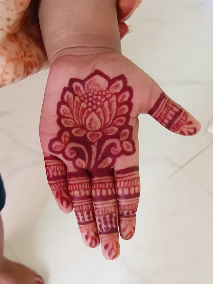 The beautiful red stain of a lotus mehndi design, just a few hours after application.
