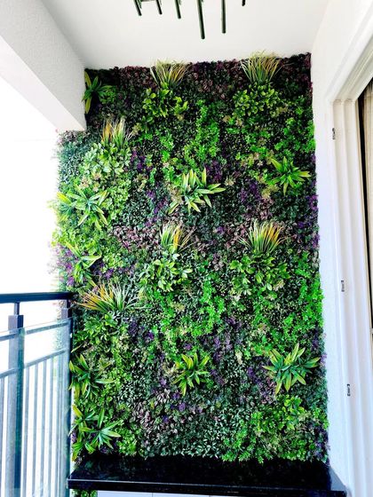 This balcony features one of our premium mixed-foliage designs. The combination of different leaf shapes, colors, and depths gives the artificial wall a very natural and dense jungle-like appearance.