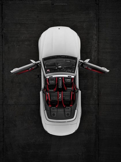 An aerial top-down shot of a white Mercedes convertible, showcasing the striking red interior and symmetrical design. This kind of drone photography provides a unique perspective that is perfect for luxury automotive brands.