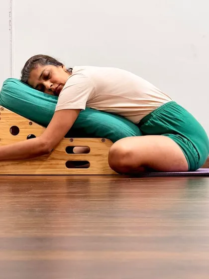 A restorative forward bend on a Simhasana Box. Guruji taught that the practice of asana and pranayama should be contained within the box of Yama and Niyama (ethical principles) to be true yoga.