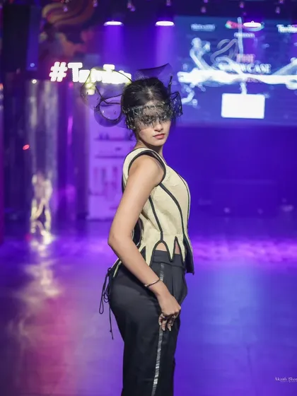 Another angle of the unique headpiece and structured vest from 'The Showcase Project', showing the detail from a side profile.
