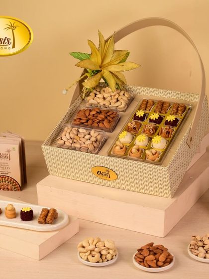 An elegant cream-colored basket filled with four types of premium dry fruits and a box of our signature assorted baklawa, perfect for any special occasion.