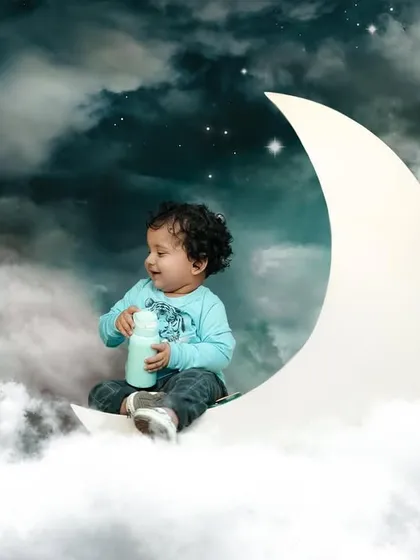A dreamy, composite image of a little boy sitting on the moon. I love creating these magical, fantasy portraits that capture the wonder of childhood.