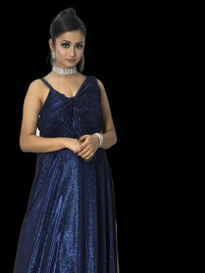 For a bold and modern look, this shimmery blue gown is a fantastic choice. The simple silhouette is elevated by the sparkling fabric, perfect for a party.