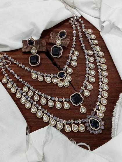 A modern take on layered necklaces, this three-strand set features deep blue stones and polki elements, perfect for a reception or cocktail party.