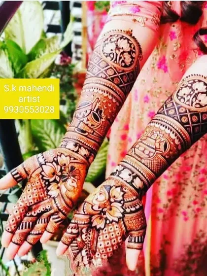 A beautiful design featuring circular mandala patterns on the arms. The palms are decorated with lotus flowers and intricate jaal work.