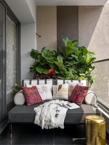The inviting balcony daybed, offering a perfect retreat surrounded by lush greenery. This piece was custom-built to maximize comfort in a compact outdoor space.