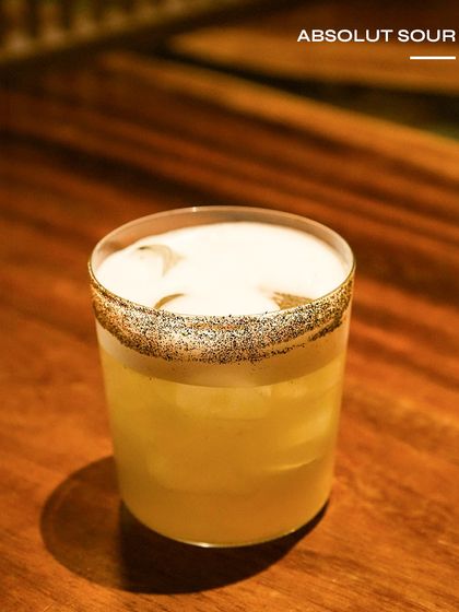 The Absolut Sour, a perfectly balanced classic. The poppy seed rim adds a unique texture and nutty flavour to this refreshing vodka sour.