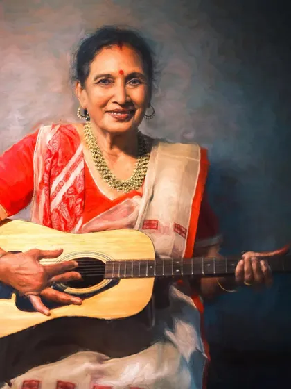 Another portrait from the 'Mothers of India' series, showing a woman in a beautiful red and white sari. Her gentle smile and the way she holds the guitar create a narrative of grace and hidden talents.