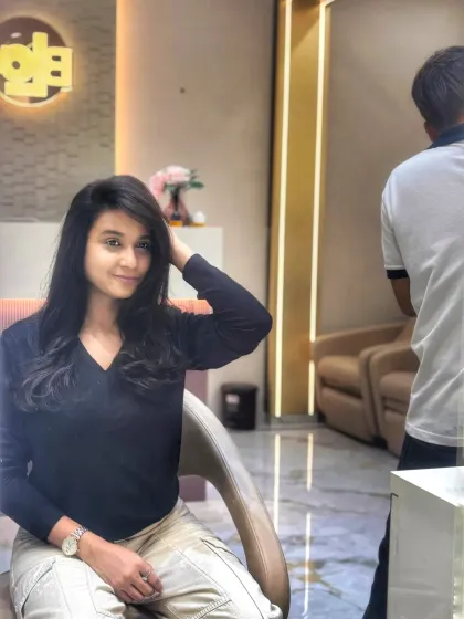 Our client feeling herself after her hair appointment. The soft layers and side-swept style look fantastic on her.